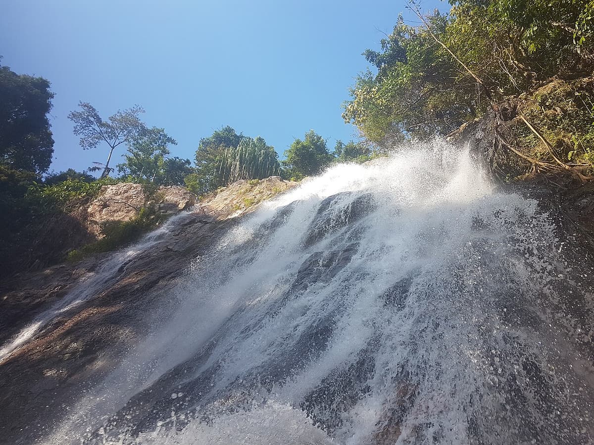 Water pouring over the rock face at Na Muang waterfall on Koh Samui